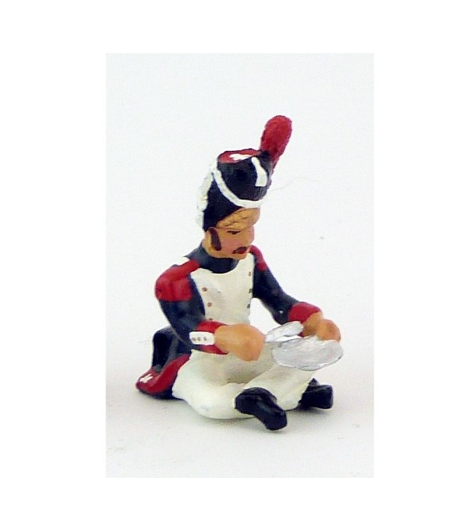 grenadier assis avec assiette et couverts