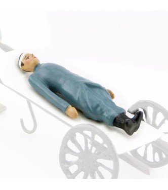 Soldat allongé en capote B. H., bandage à la tête (pour Side-Car ou Brancard)