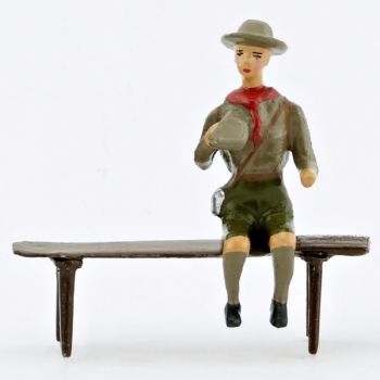 scout assis sur un banc avec gourde