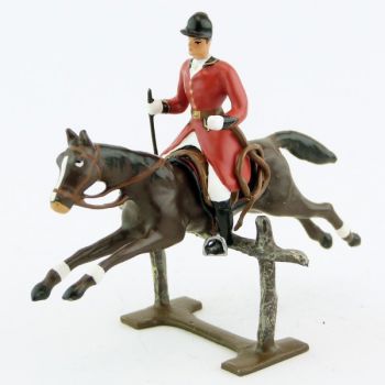 cavalier avec cravache sur cheval marron (bai) sautant barrière