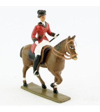 cavalière (cravache) sur cheval alezan au pas