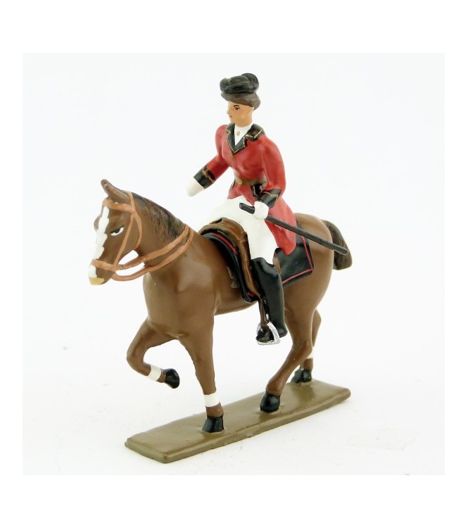 cavalière (cravache) sur cheval alezan au pas