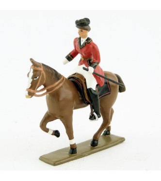 cavalière (cravache) sur cheval alezan au pas