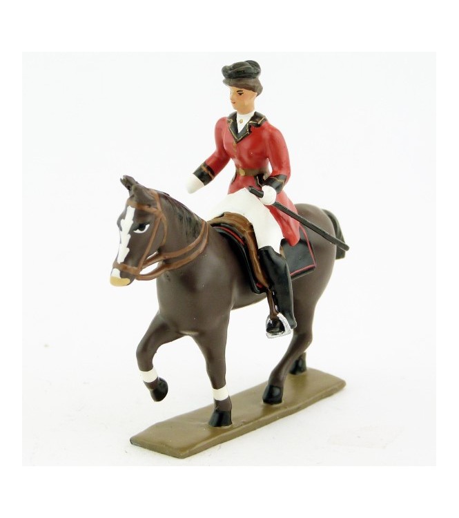 cavalière (cravache) sur cheval marron (bai) au pas