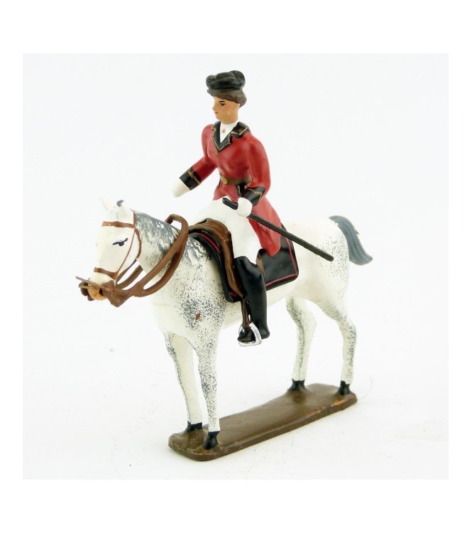 cavalière (cravache) sur cheval blanc debout