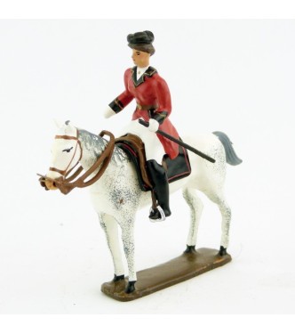 cavalière (cravache) sur cheval blanc debout