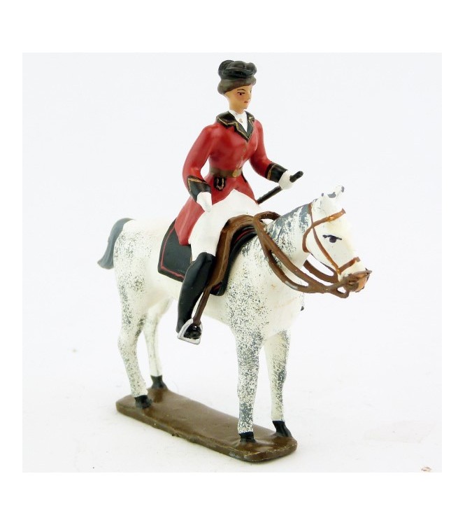 cavalière (cravache) sur cheval blanc debout