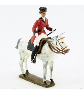 cavalière (cravache) sur cheval blanc debout