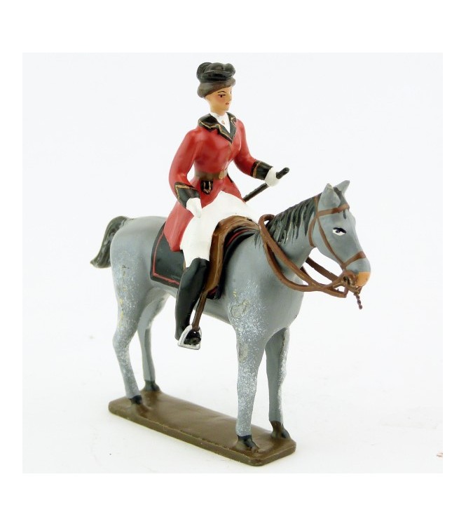 cavalière (cravache) sur cheval gris debout
