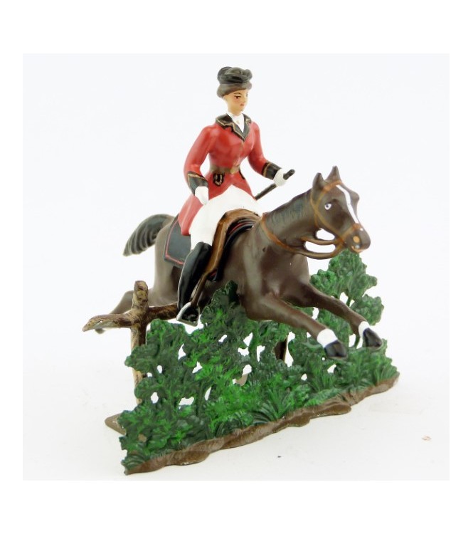 cavalière (cravache) sur cheval marron sautant haie + barrière