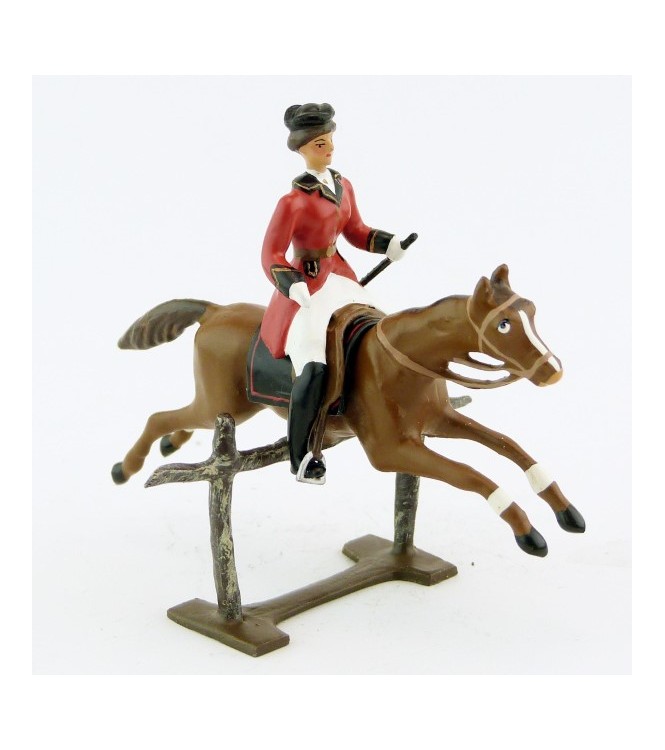 cavalière (cravache) sur cheval alezan sautant barrière