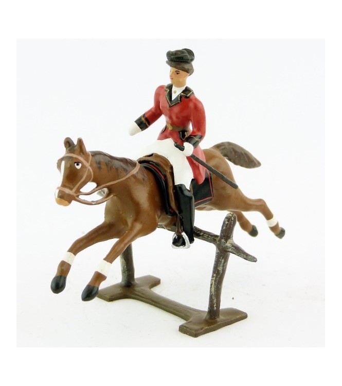 cavalière (cravache) sur cheval alezan sautant barrière