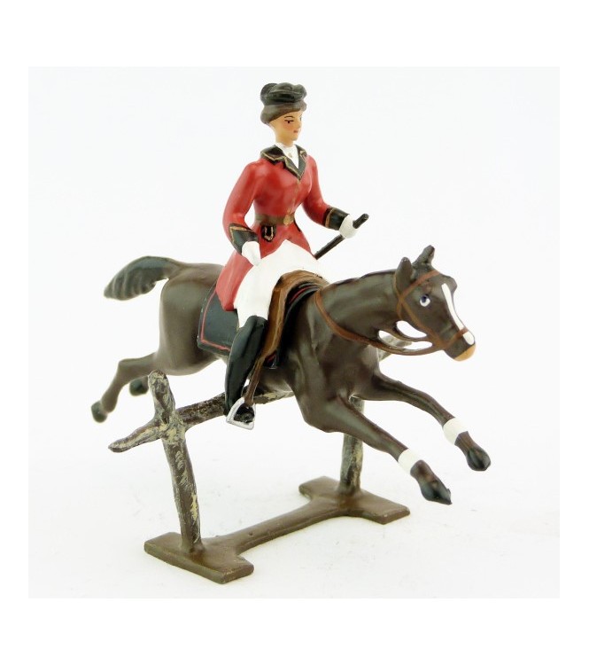 cavalière (cravache) sur cheval marron sautant barrière