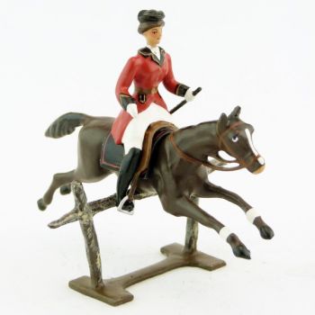 cavalière (cravache) sur cheval marron sautant barrière