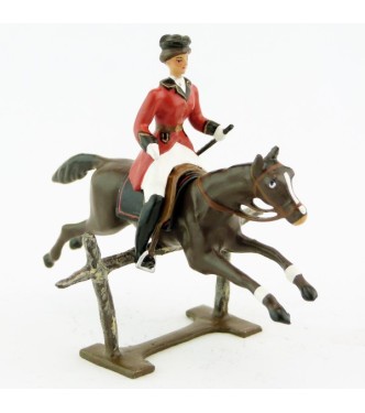 cavalière (cravache) sur cheval marron sautant barrière