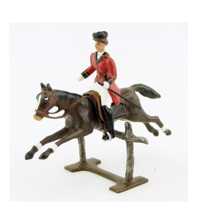 cavalière (cravache) sur cheval marron sautant barrière