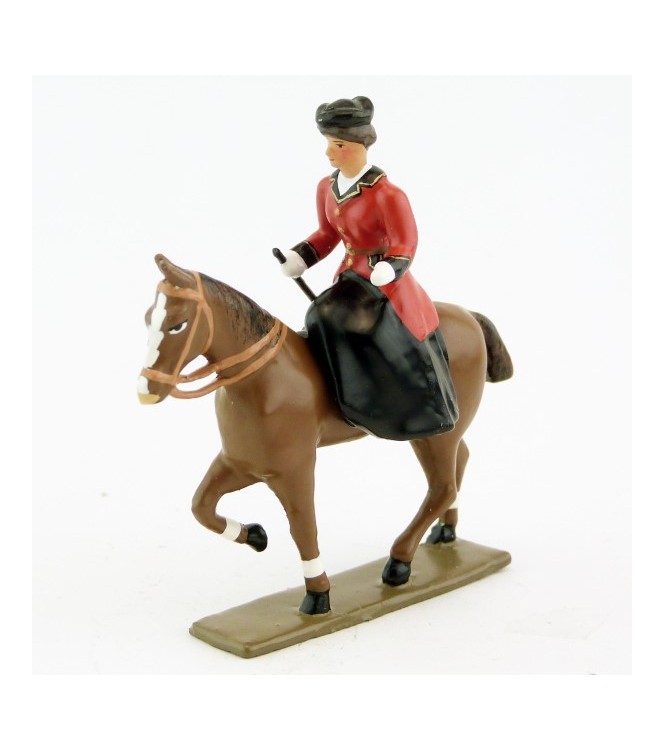 cavalière en amazone sur cheval alezan au pas