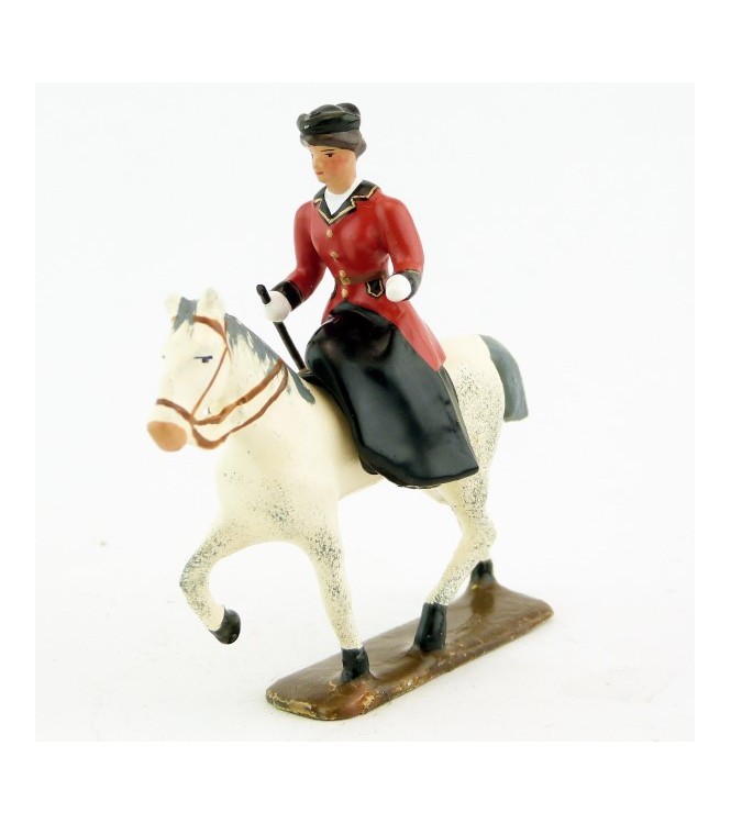 cavalière en amazone sur cheval blanc au pas