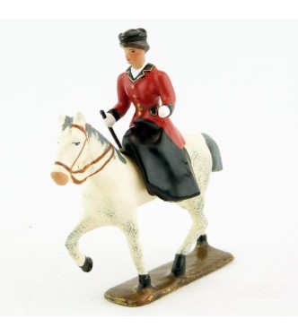 cavalière en amazone sur cheval blanc au pas