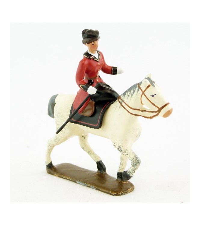 cavalière en amazone sur cheval blanc au pas