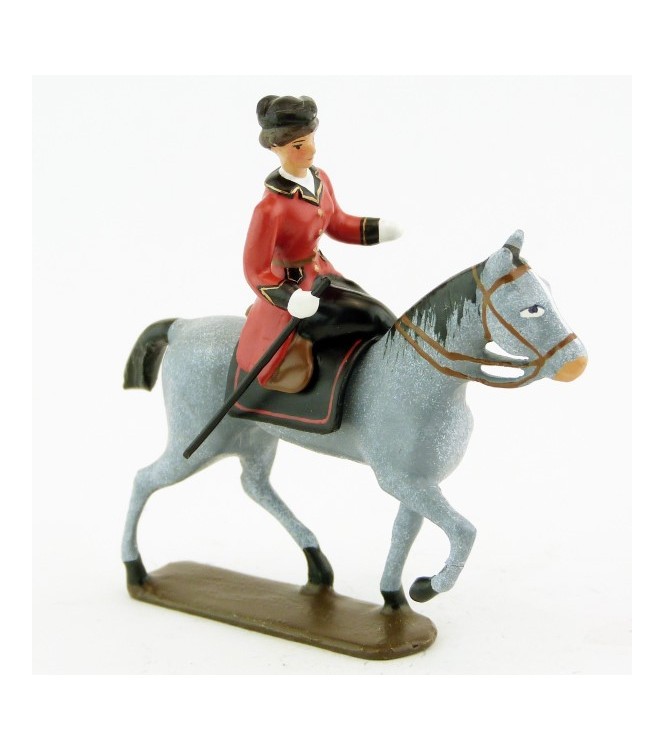 cavalière en amazone sur cheval gris au pas