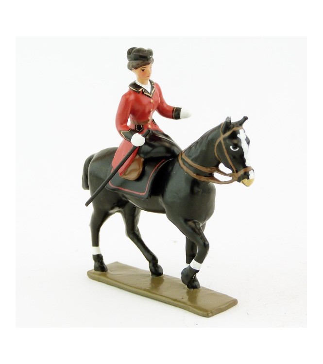 cavalière en amazone sur cheval noir au pas