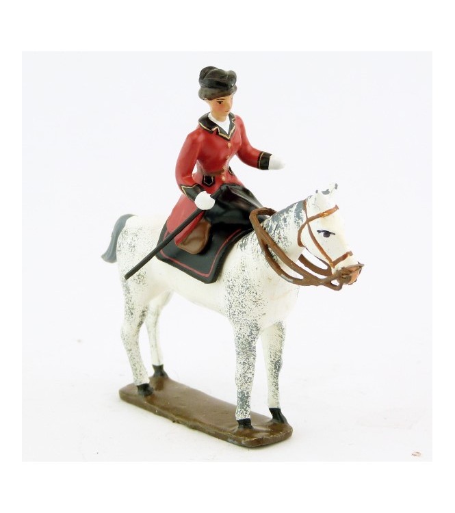 cavalière en amazone sur cheval blanc debout