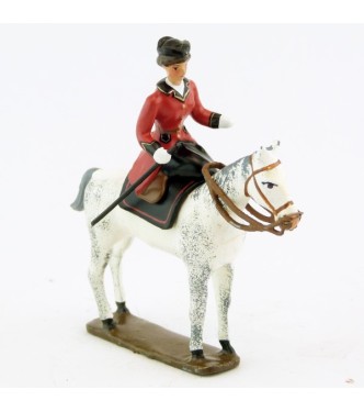 cavalière en amazone sur cheval blanc debout