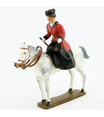 cavalière en amazone sur cheval blanc debout