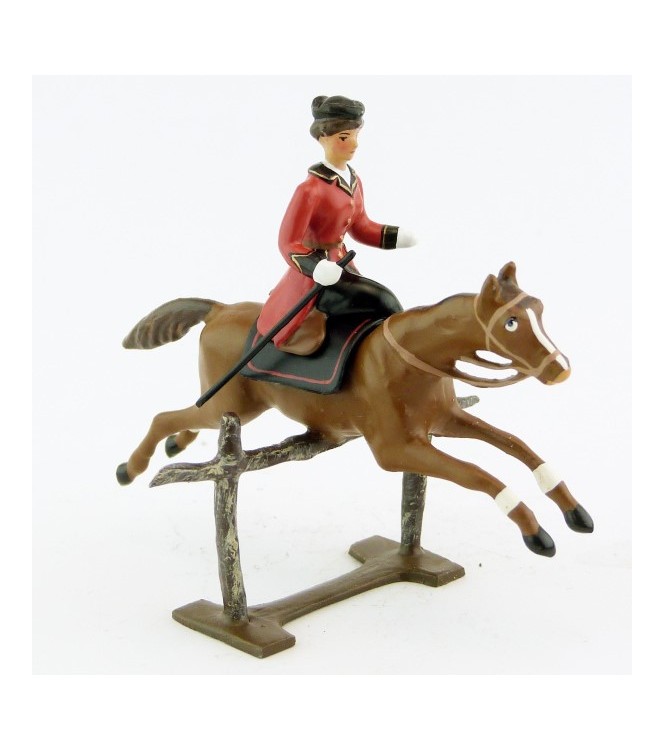 cavalière en amazone sur cheval alezan sautant barrière