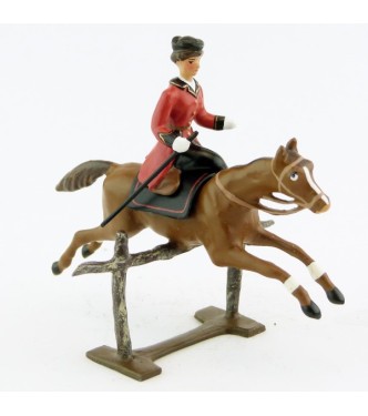 cavalière en amazone sur cheval alezan sautant barrière