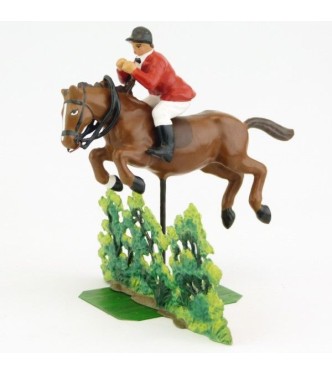 cavalier de Chasse à courre sautant un buisson